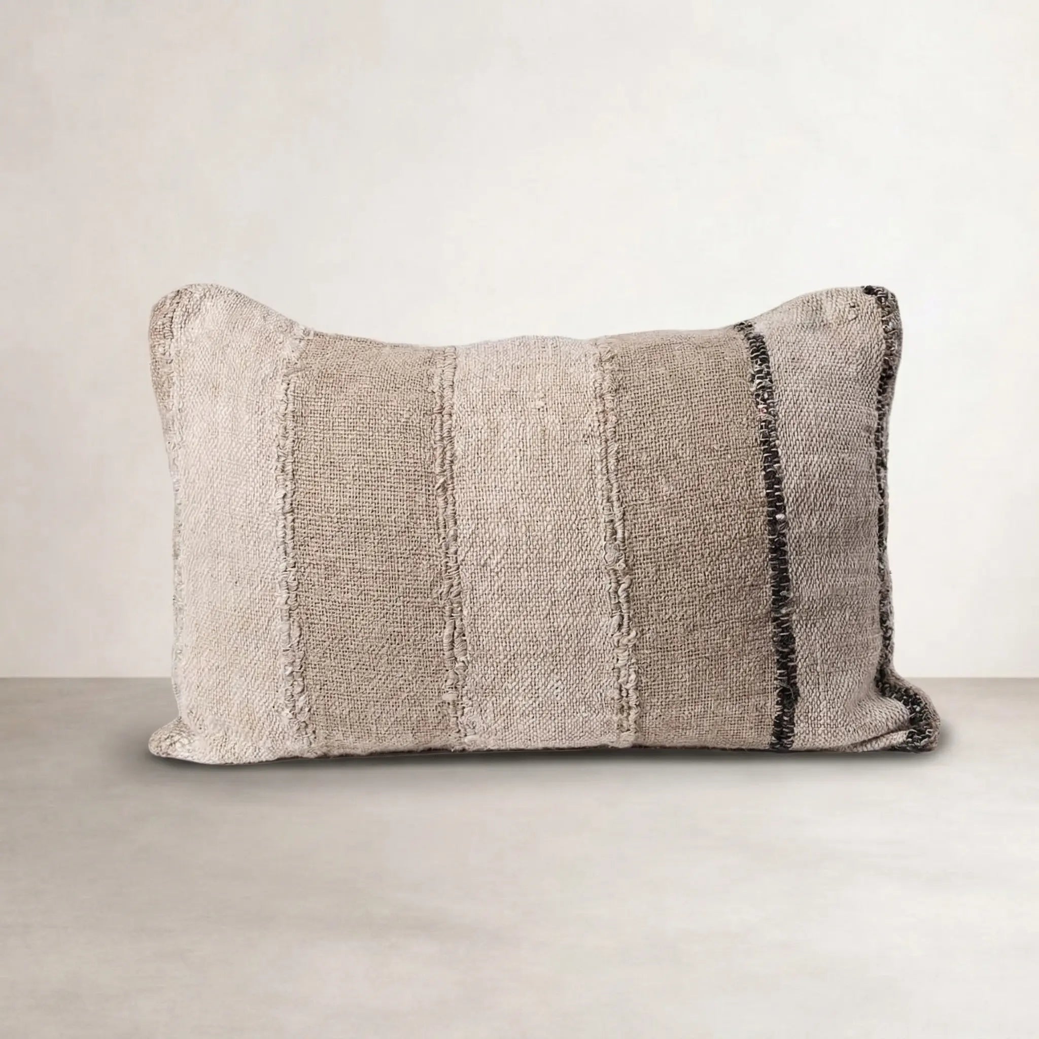 Retreat Linen Cushion — handwoven stripe fabric with a feather insert holding its shape
