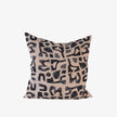 Abstract black print cushion on nude linen, square decorative cushion on white background