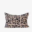 Abstract black print cushion on nude linen, rectangular decorative cushion