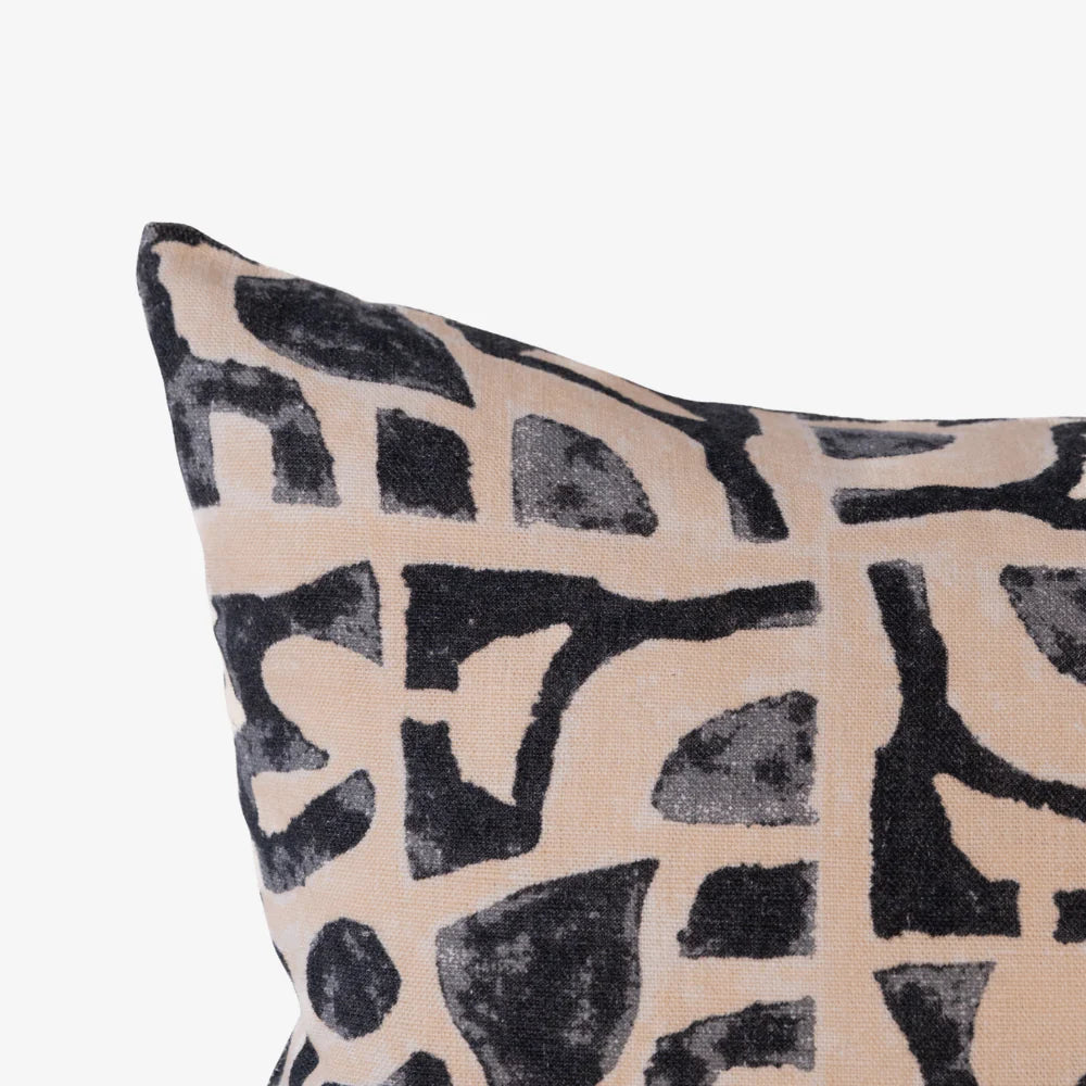 Abstract black print cushion on nude linen, square decorative cushion close-up