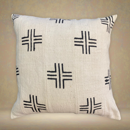 Decorative pillow with black geometric patterns on a beige background