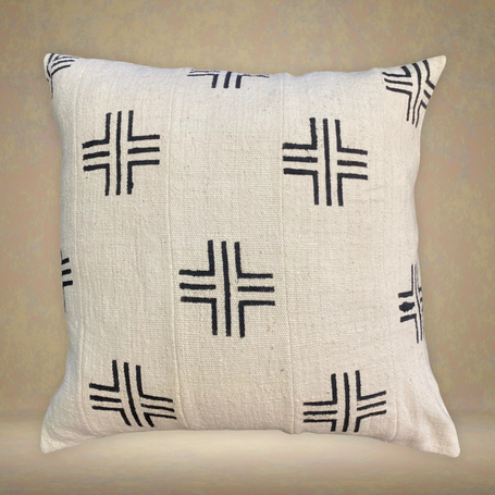 Decorative pillow with black geometric patterns on a beige background