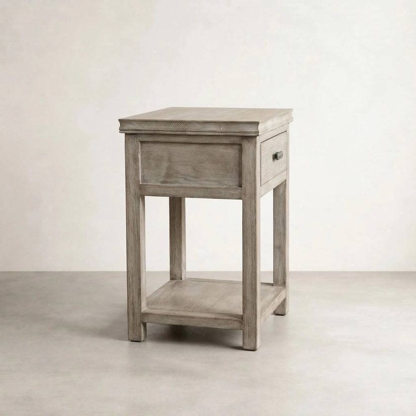 Light timber bedside table with single drawer and lower shelf on neutral background