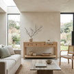 Modern living room with wooden console table, sofa, and chairs.