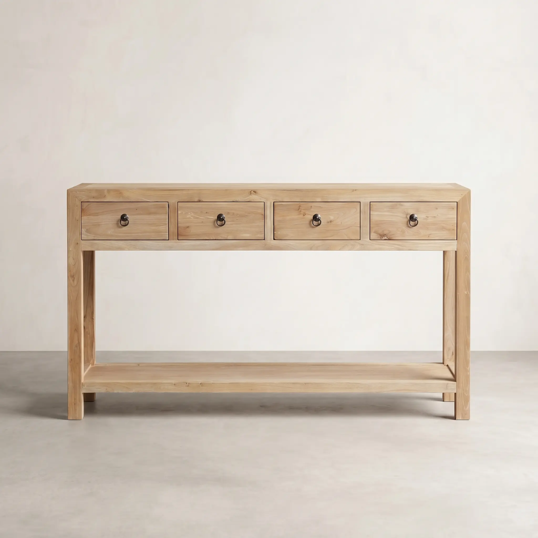 Wooden console table with four drawers on a plain background