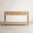Wooden console table with four drawers on a plain background