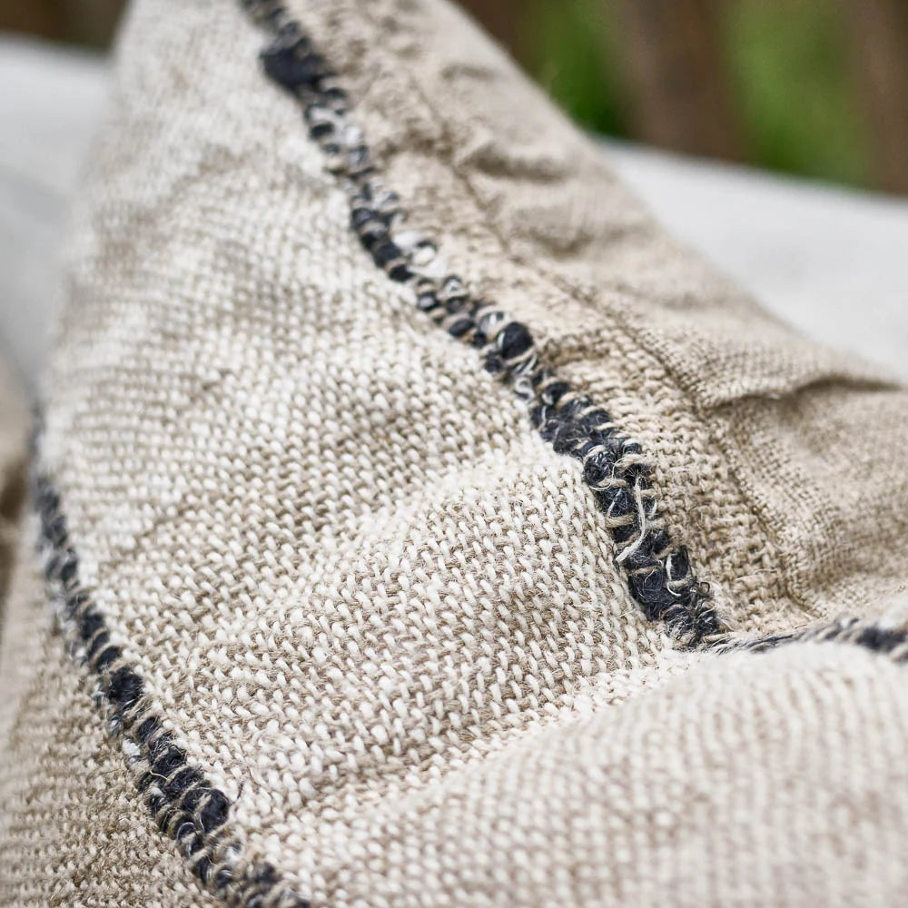 Retreat Linen Cushion — rustic weave detail in natural, ivory and black