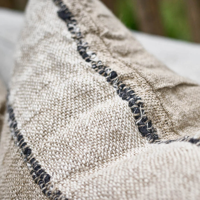 Retreat Linen Cushion — rustic weave detail in natural, ivory and black