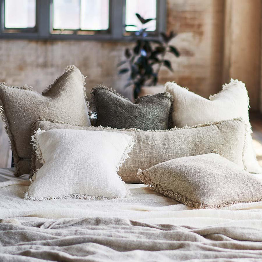 Coastalis Living + Design Bedouin Cushion range in Natural and Ivory styled on bed with white linen