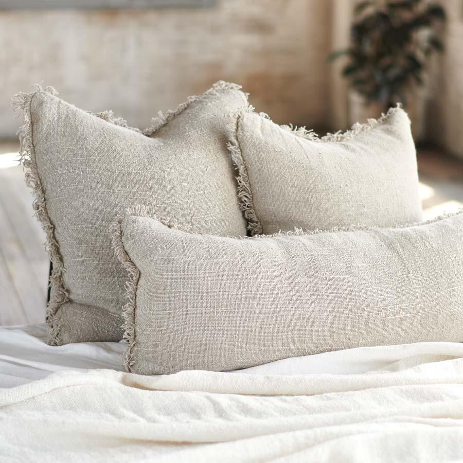 Coastalis Living + Design Bedouin Linen Cushions in Natural styled on bed with white linen bedding