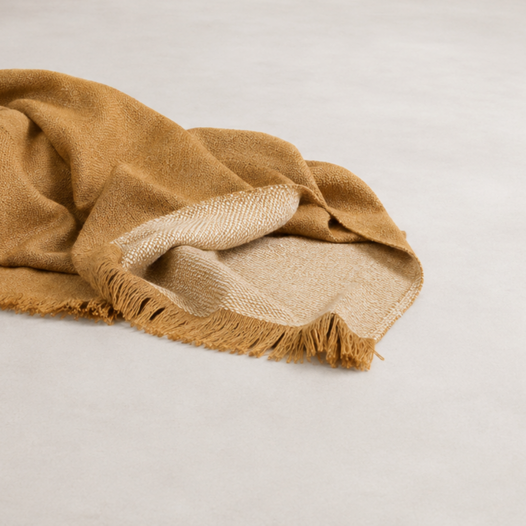 Faro Throw - Toffee — double-faced woven throw anchoring a sofa
