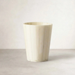 Inlaid bone vase, front view on neutral background showing vertical bone inlay strips