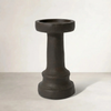 a cement candle holder in black and natural