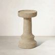 a cement candle holder in black and natural