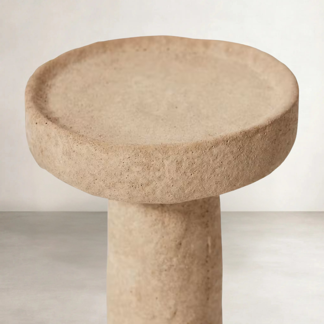 a cement candle holder in black and natural