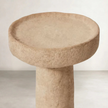 a cement candle holder in black and natural