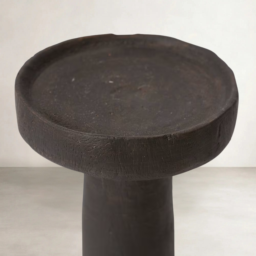 a cement candle holder in black and natural
