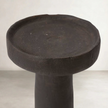 a cement candle holder in black and natural