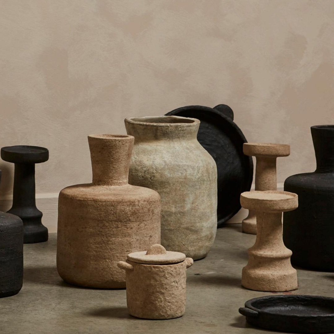 a cement candle holder in black and natural