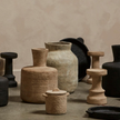 a cement candle holder in black and natural