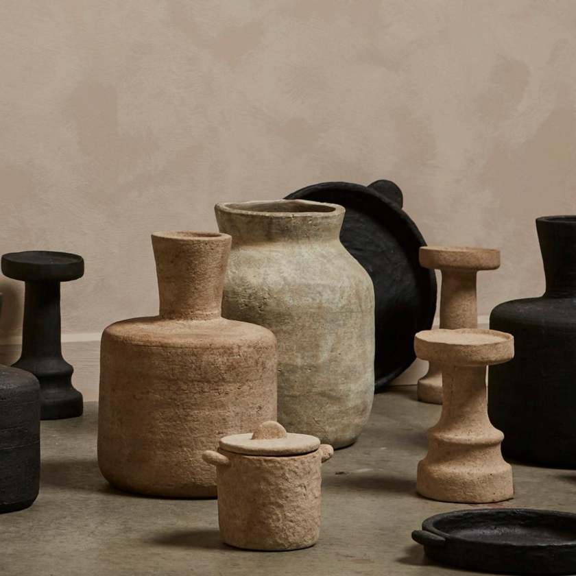 a cement candle holder in black and natural