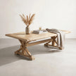 Wooden dining table with decorative items on a plain background