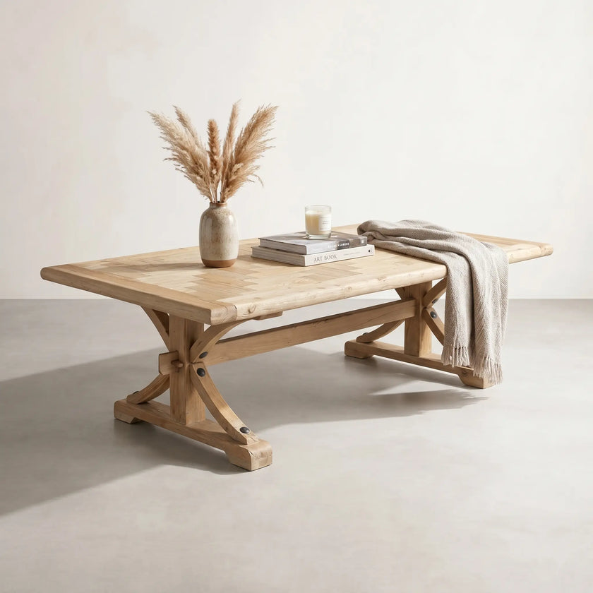 Wooden dining table with decorative items on a plain background