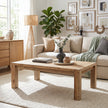 Living room with a wooden coffee table, beige sofa, and decorative elements.