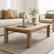 Living room with a wooden coffee table, beige sofa, and wicker chair.