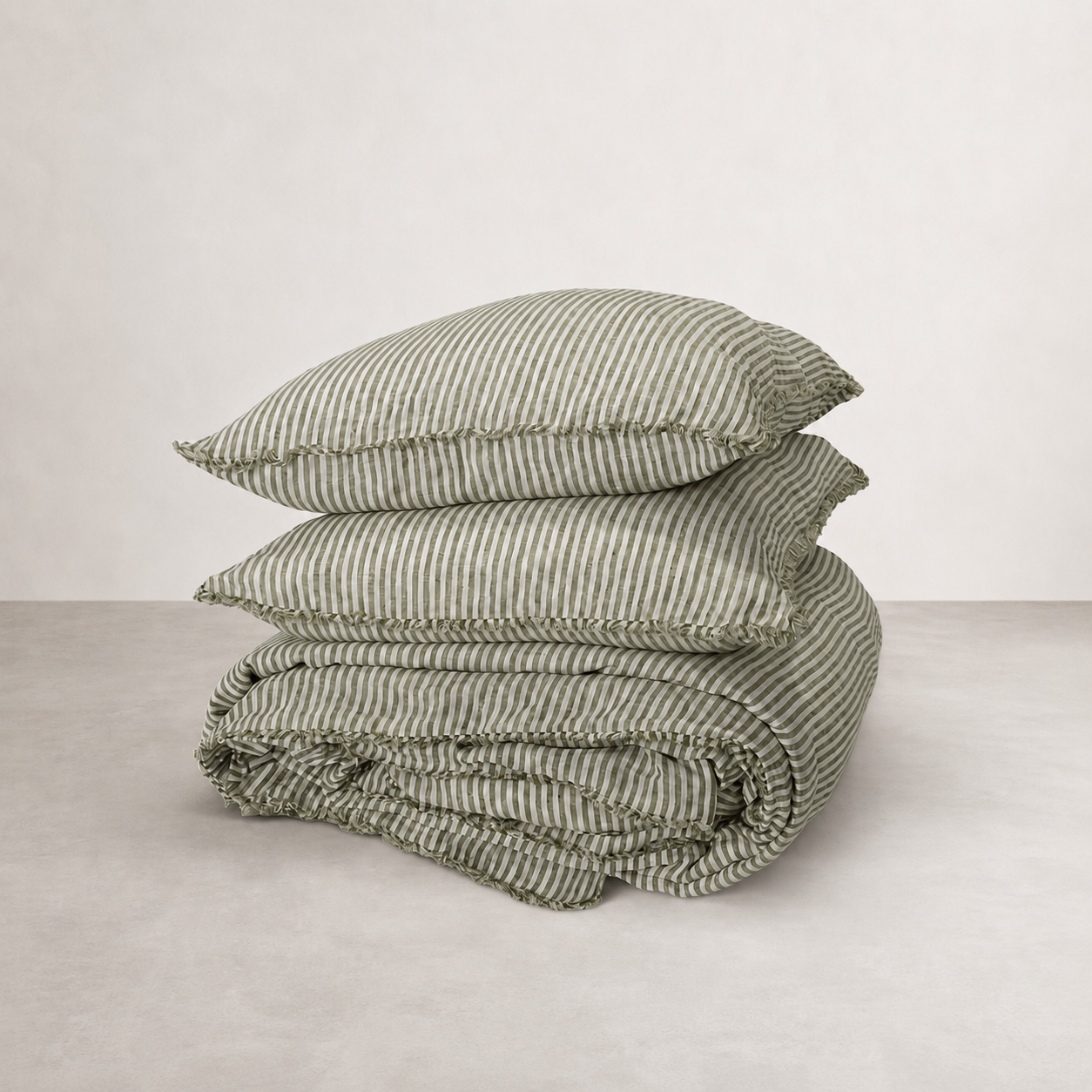 French flax linen quilt cover in olive pencil stripe, folded with matching pillowcases