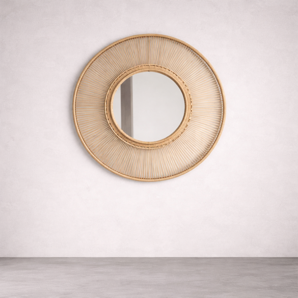 Round rattan mirror on a white wall