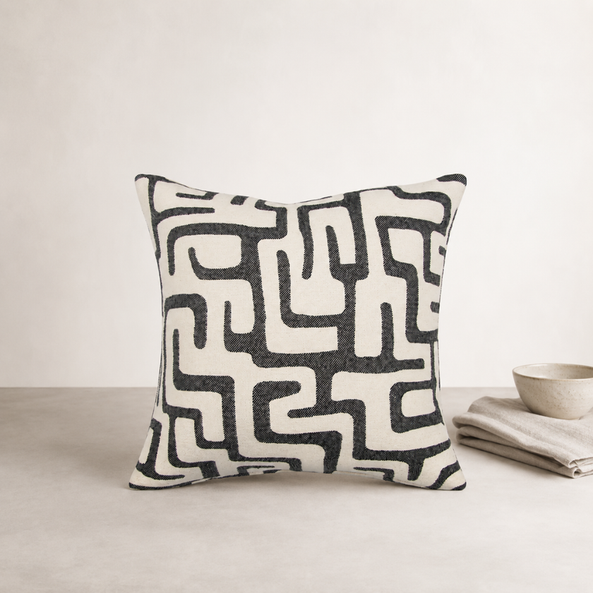 Toma Cushion — Black — irregular graphic pattern sitting in soft relief
